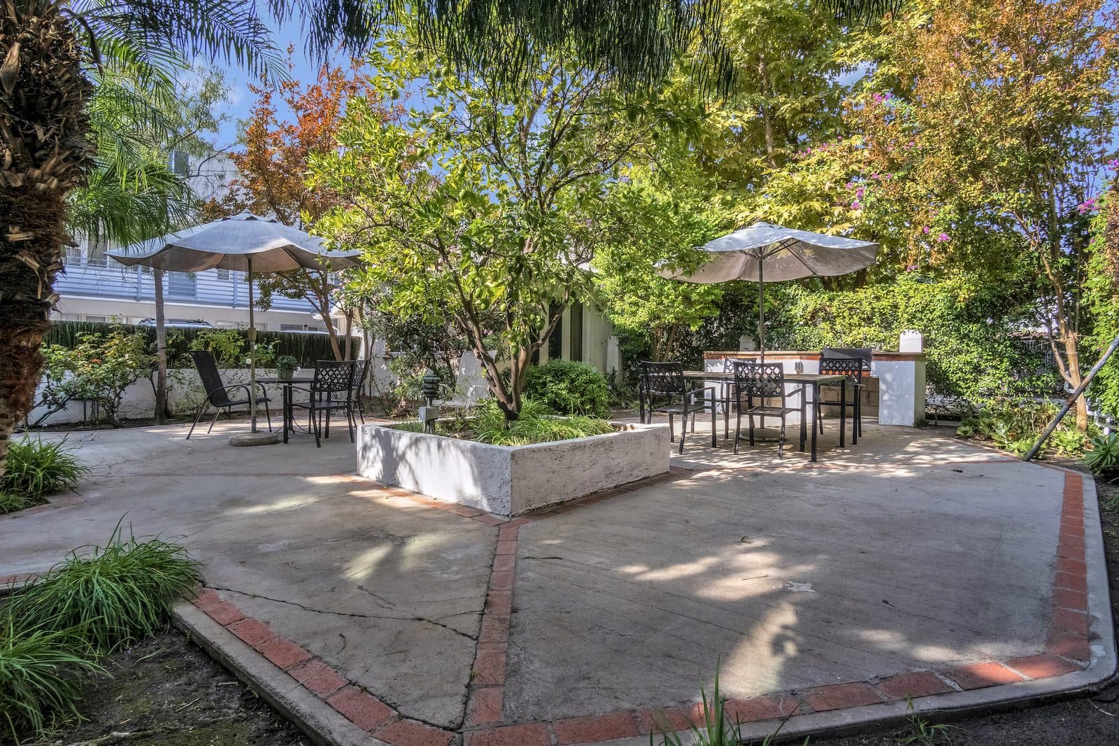 Common garden patio with tables and umbrellas