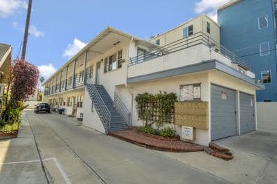 Two-story apartment building with its exterior stair over the motor court