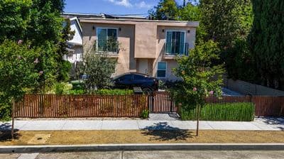 Front elevation and gated entry at 11025 Blix