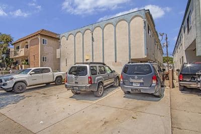 Arcaded facade from the north with resident parking