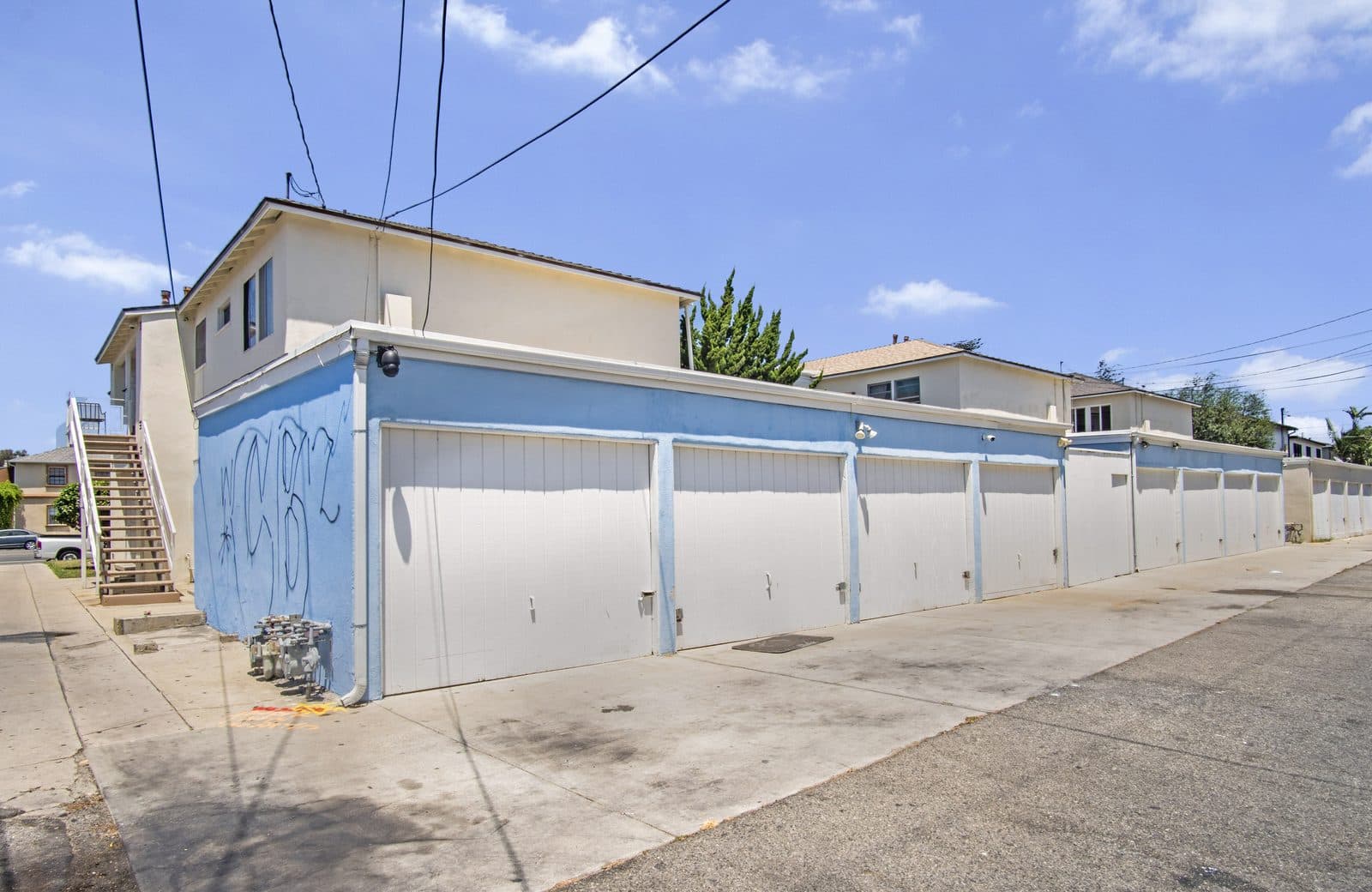 Garage row serving both buildings, source of the parking income