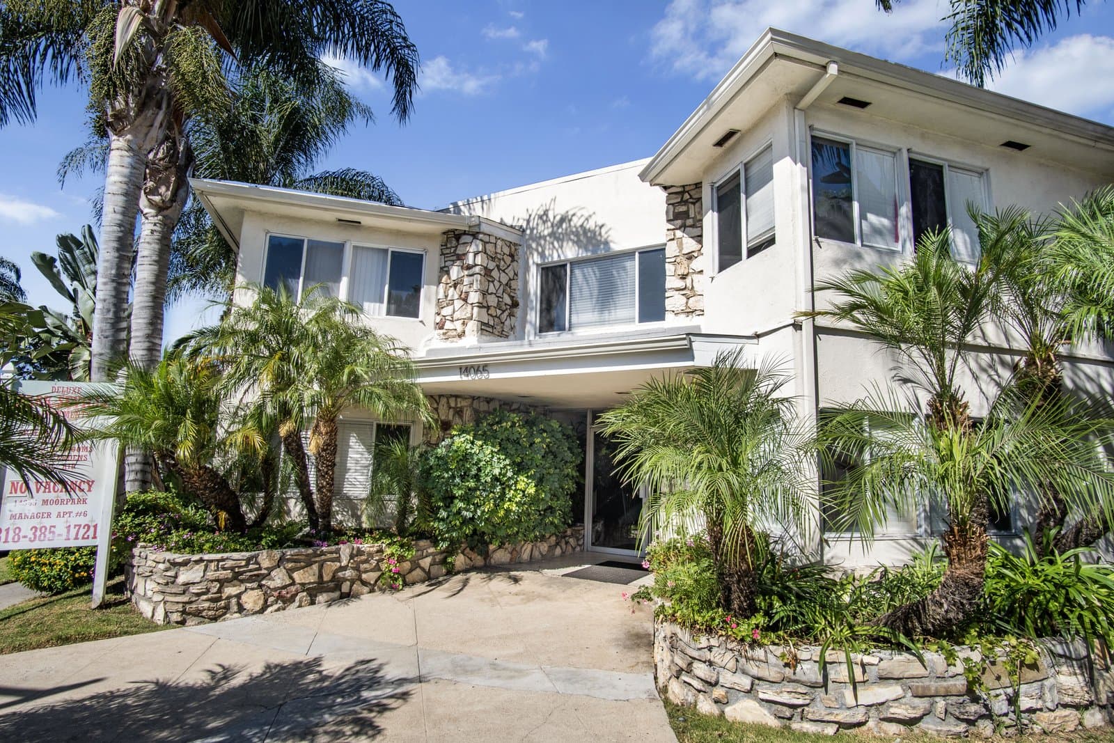 Front entry with stone accents under the palms