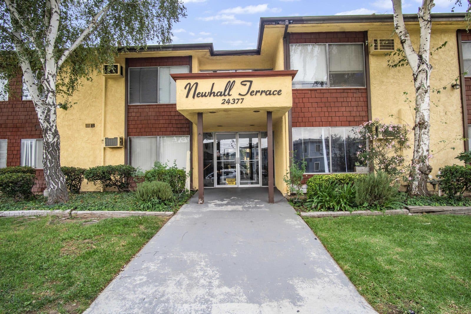 Front entry under the Newhall Terrace sign on Newhall Avenue