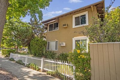 Side elevation behind the white picket fence