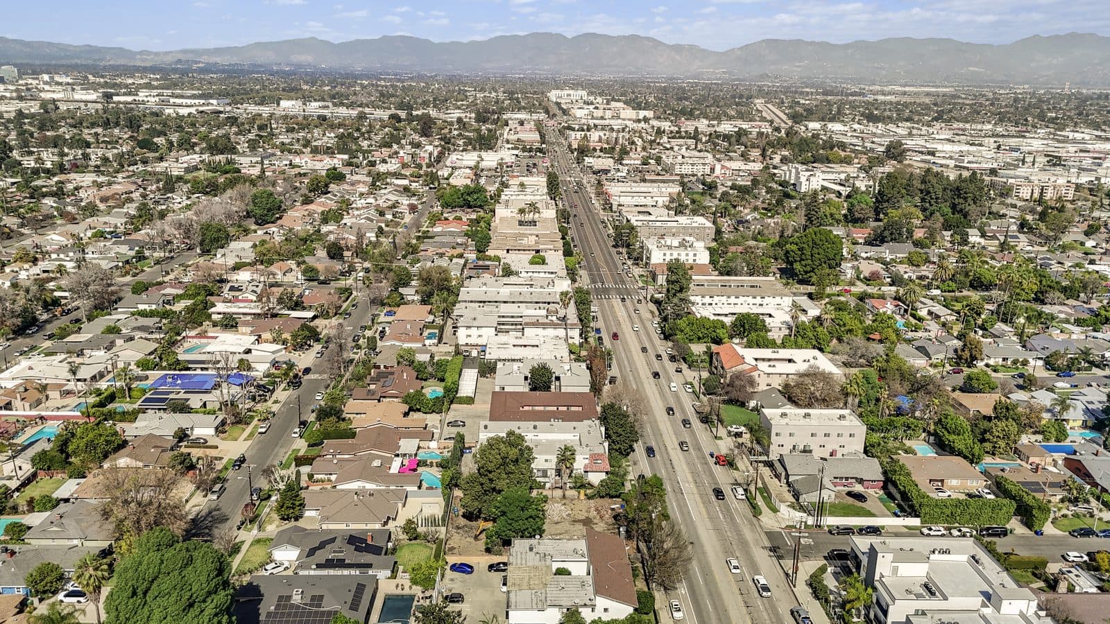 Aerial context view of the Van Nuys corridor with the San Gabriel Mountains beyond