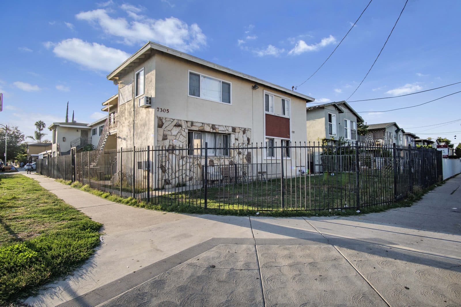 Corner elevation and fenced lawn
