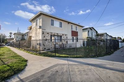 Corner elevation and fenced lawn